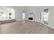 Open-concept living room with wood-style flooring, a modern fireplace, and sliding glass doors at 6509 Old Oxford Ave, Las Vegas, NV 89108