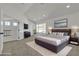 Spacious main bedroom with a vaulted ceiling, soft carpet, natural light, and modern decor at 6509 Old Oxford Ave, Las Vegas, NV 89108