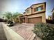 Charming two-story home with a brick driveway, attached garage, and well-manicured landscaping at 6639 Ivory Dove Ct, Las Vegas, NV 89148