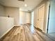 Hallway with wood-look flooring and multiple doors at 6639 Ivory Dove Ct, Las Vegas, NV 89148