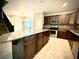 Open kitchen featuring granite countertops, stainless steel appliances, and tile flooring at 6639 Ivory Dove Ct, Las Vegas, NV 89148