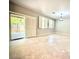 Spacious living room with tiled floors, lots of natural light, and a sliding glass door to the backyard at 6639 Ivory Dove Ct, Las Vegas, NV 89148