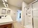 Bright bathroom featuring double sinks, modern fixtures, and a glass-enclosed shower at 6868 Sky Pointe Dr # 2013, Las Vegas, NV 89131
