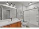 Bright bathroom with modern vanity, framed mirror, and glass enclosed shower and tub at 6868 Sky Pointe Dr # 2013, Las Vegas, NV 89131