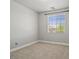 Empty bedroom with neutral carpet and paint, complemented by a large window at 6868 Sky Pointe Dr # 2013, Las Vegas, NV 89131