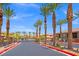 Community entrance with gated access, lush palm trees, and well-maintained landscaping at 6868 Sky Pointe Dr # 2013, Las Vegas, NV 89131