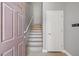 Entryway with an open door, stairs, and a white door, offering a welcoming entrance at 6868 Sky Pointe Dr # 2013, Las Vegas, NV 89131