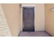 Secured front door with a decorative metal screen and exterior light fixture, adding charm and security at 6868 Sky Pointe Dr # 2013, Las Vegas, NV 89131