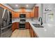 Modern kitchen with stainless steel appliances, wood cabinets, and white countertops at 6868 Sky Pointe Dr # 2013, Las Vegas, NV 89131