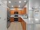 Open kitchen featuring stainless steel appliances, wooden cabinetry, and island with sink at 6868 Sky Pointe Dr # 2013, Las Vegas, NV 89131