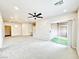 Open-concept living room with carpet, recessed lights, and a sliding glass door to the outdoors at 6868 Sky Pointe Dr # 2013, Las Vegas, NV 89131