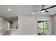Bright living room featuring a ceiling fan and sliding glass doors to a balcony with artificial turf at 6868 Sky Pointe Dr # 2013, Las Vegas, NV 89131