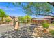 Community playground featuring play structures, seating, and mature shade trees at 6868 Sky Pointe Dr # 2013, Las Vegas, NV 89131
