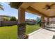 Covered patio overlooking the spacious backyard with artificial turf, trampoline, and play area at 7256 Bugler Swan Way, North Las Vegas, NV 89084