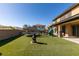 Spacious backyard with artificial grass, trampoline, playground and a fire pit, ideal for outdoor activities at 7256 Bugler Swan Way, North Las Vegas, NV 89084
