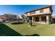 Large backyard with artificial grass, covered patio, trampoline, fire pit and play area at 7256 Bugler Swan Way, North Las Vegas, NV 89084