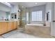 Bathroom featuring a separate glass shower, soaking tub and tile flooring, perfect for relaxation at 7256 Bugler Swan Way, North Las Vegas, NV 89084