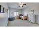 Neutral-colored bedroom has a single bed, window, carpet, and closet at 7256 Bugler Swan Way, North Las Vegas, NV 89084