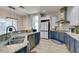 Bright kitchen featuring modern appliances, granite countertops, and ample cabinet space at 7256 Bugler Swan Way, North Las Vegas, NV 89084