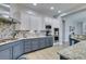 Modern kitchen featuring granite countertops, stainless steel appliances, and stylish backsplash at 7256 Bugler Swan Way, North Las Vegas, NV 89084