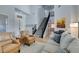 Bright living room view featuring a staircase, piano, comfortable seating and a two-story ceiling at 7256 Bugler Swan Way, North Las Vegas, NV 89084