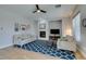 Bright living room with a fireplace and a blue patterned rug at 7256 Bugler Swan Way, North Las Vegas, NV 89084