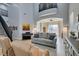 Bright living room featuring a staircase, piano, comfortable seating and two-story ceilings at 7256 Bugler Swan Way, North Las Vegas, NV 89084