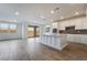 Modern kitchen with white cabinets, center island with sink, stainless appliances, and recessed lighting at 785 Black Palace St, Henderson, NV 89011