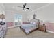 Cozy bedroom with soft lighting, private balcony access and a ceiling fan at 807 Canyon Greens Dr, Las Vegas, NV 89144