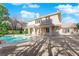 Beautiful backyard pool and spa with views of the home's exterior architecture at 807 Canyon Greens Dr, Las Vegas, NV 89144
