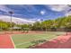 Community tennis courts with well-maintained playing surfaces, surrounded by mature trees and professional lighting at 807 Canyon Greens Dr, Las Vegas, NV 89144