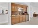 Charming wet bar with custom cabinetry, granite countertop, and beverage fridge at 807 Canyon Greens Dr, Las Vegas, NV 89144