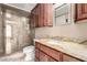 This bathroom showcases a glass shower and vanity with a granite countertop and dark cabinets at 9000 Las Vegas Blvd # 2243, Las Vegas, NV 89123