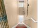 Carpeted stairs leading downstairs with white walls and decorative wall sconces at 9000 Las Vegas Blvd # 2243, Las Vegas, NV 89123
