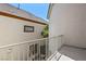 Balcony with white railing overlooking a landscaped neighborhood at 9228 Whitekirk Pl, Las Vegas, NV 89145