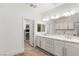 Bathroom with double sink vanity, large mirrors and storage, and walk-in closet at 9228 Whitekirk Pl, Las Vegas, NV 89145