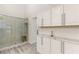 Bathroom features a glass enclosed shower, marble counters and tile, and vanity storage at 9228 Whitekirk Pl, Las Vegas, NV 89145