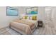 Staged bedroom with a comfortable bed and decorative artwork and hallway access at 9228 Whitekirk Pl, Las Vegas, NV 89145