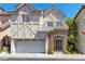 Charming two-story home with Tudor-style accents, a front porch, and a two-car garage at 9228 Whitekirk Pl, Las Vegas, NV 89145