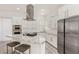 Modern kitchen boasts stainless steel appliances, a gas cooktop, and a granite countertop island with seating at 9228 Whitekirk Pl, Las Vegas, NV 89145