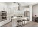 Modern kitchen boasts stainless steel appliances, a gas cooktop, and a granite countertop island with seating at 9228 Whitekirk Pl, Las Vegas, NV 89145