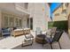 Private outdoor patio with comfortable seating, a fire pit, and a decorative green wall at 9228 Whitekirk Pl, Las Vegas, NV 89145