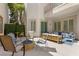 Private outdoor patio with comfortable seating, a fire pit, and a decorative green wall at 9228 Whitekirk Pl, Las Vegas, NV 89145