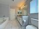 Well-lit bathroom featuring a double vanity, marble floors, and ample space at 9509 Arrowhead Falls Ct, Las Vegas, NV 89148