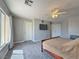 Bright bedroom features a ceiling fan, wall-mounted television, and neutral colors at 9509 Arrowhead Falls Ct, Las Vegas, NV 89148