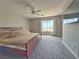 Spacious bedroom featuring a large window, neutral colors, and a ceiling fan at 9509 Arrowhead Falls Ct, Las Vegas, NV 89148