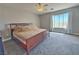 Bright bedroom featuring a large window, neutral colors, and a ceiling fan at 9509 Arrowhead Falls Ct, Las Vegas, NV 89148