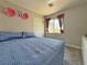 Comfortable bedroom features a closet, window, and neutral colors at 9509 Arrowhead Falls Ct, Las Vegas, NV 89148
