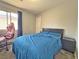 Cozy bedroom features a comfortable bed, gaming chair, and a sunny window at 9509 Arrowhead Falls Ct, Las Vegas, NV 89148