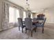 Cozy dining room features a round table, decorative chandelier, and natural light from the large window at 9509 Arrowhead Falls Ct, Las Vegas, NV 89148